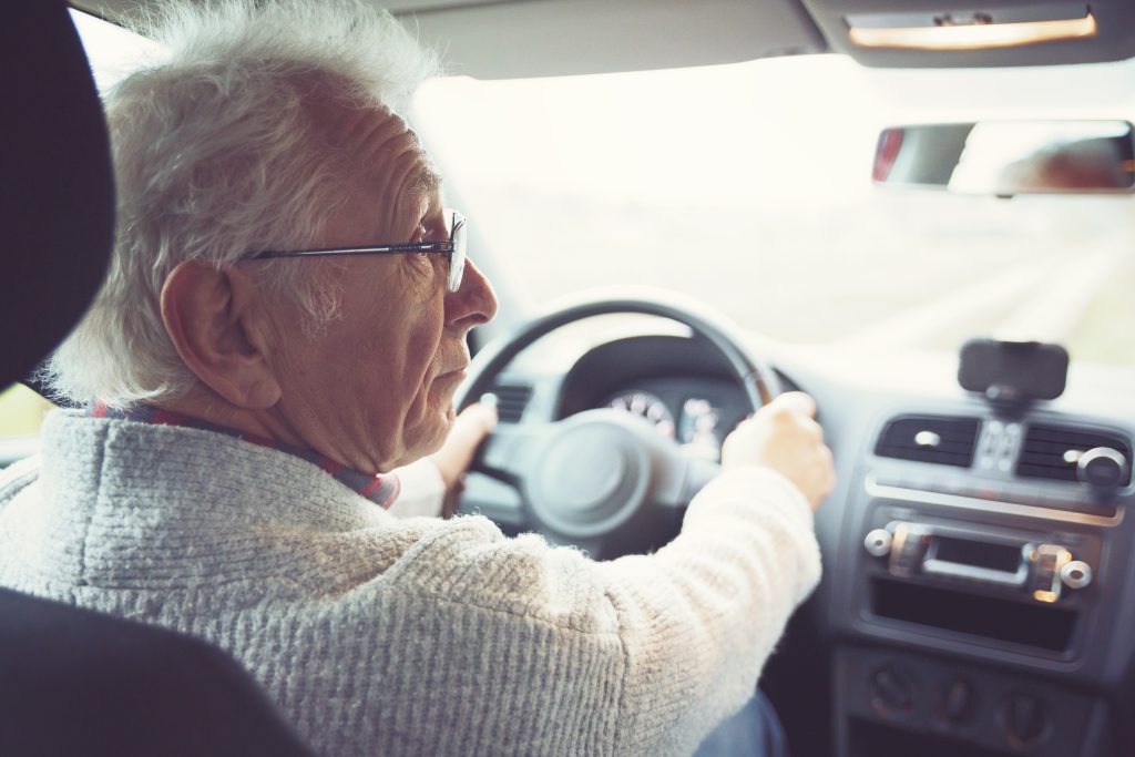 Elderly gentleman driving a car